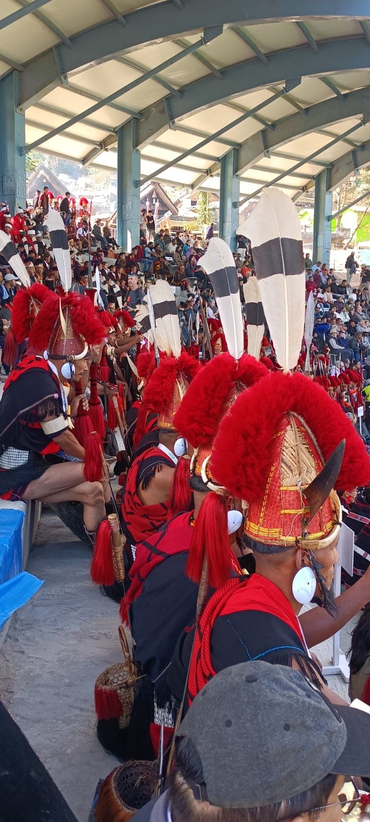 Red woven crafts and traditional hats displayed at a market stall